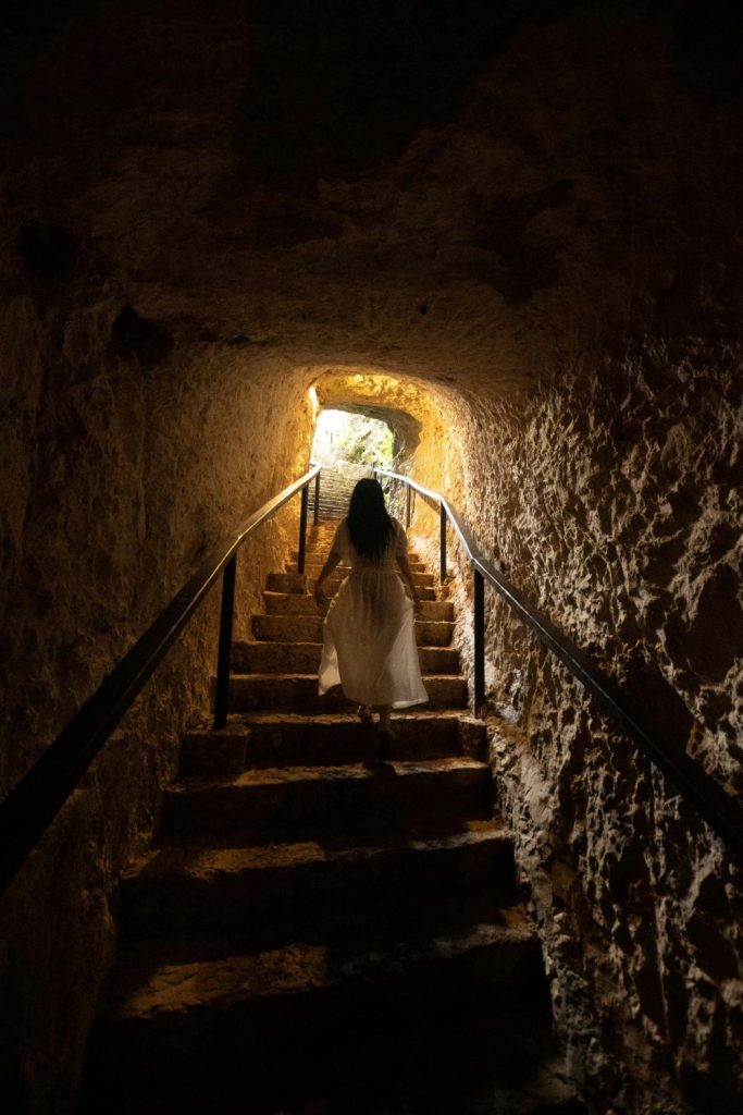 woman climbing towards the light